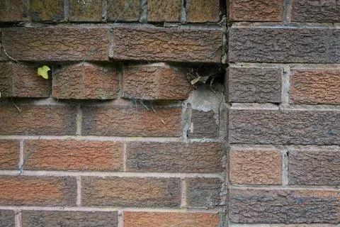 A brick wall with a hole in it Stock Photos
