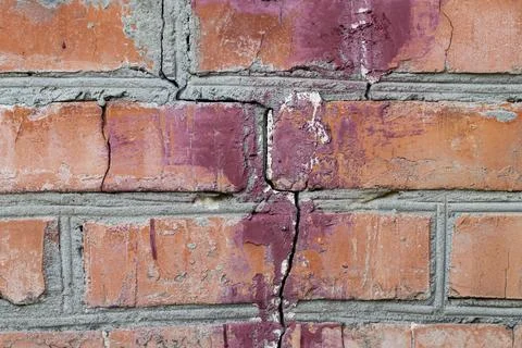 A brick wall with a large crack.The consequences of technology violations in  Stock Photos