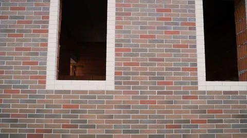 Brick wall made of expensive multi-colored bricks. corner of a textural build Stock Photos