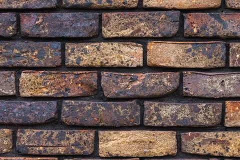 Brick wall made of multi-colored bricks Stock Photos