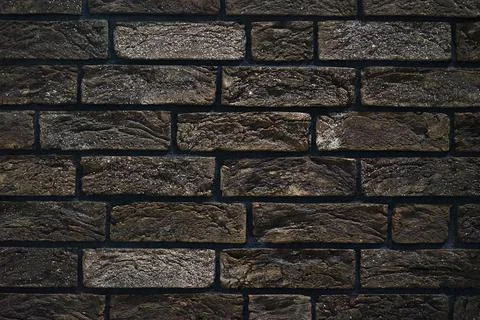 Brick wall made of textured decorative brick. Stock Photos