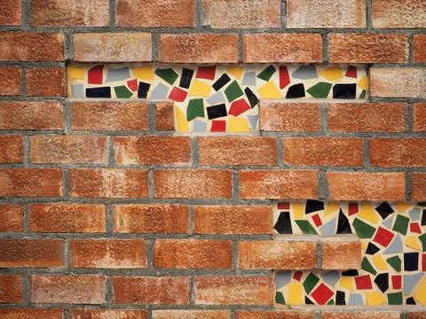 Brick wall with mosaic insert Stock Photos