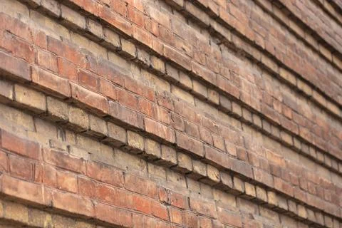 Brick wall of an old building. An ancient architectural structure made Stock Photos