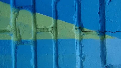 Brick wall painted in different bright colors Stock Photos