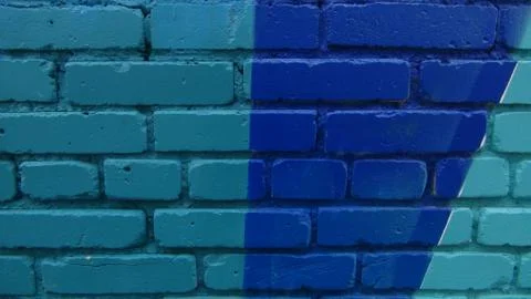 Brick wall painted in different bright colors Stock Photos