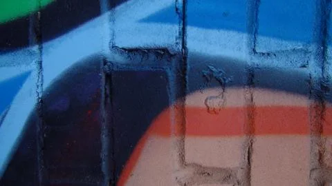 Brick wall painted in different bright colors Stock Photos