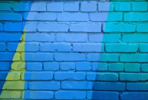 Brick wall painted in different bright colors Foto stock