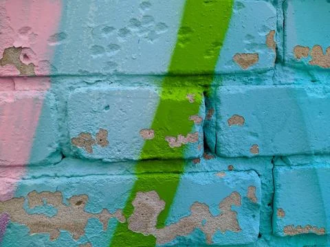 Brick wall painted in different bright colors. Stock Photos