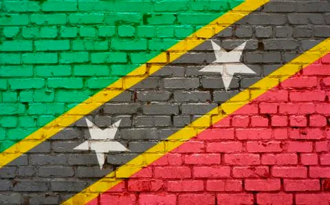 Brick wall with painted flag of St Kitts and Nevis Stock Photos