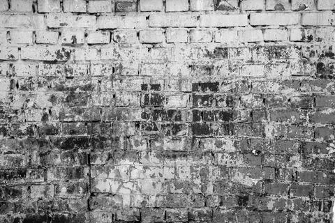 Brick wall painted with paint surface for background. Brick wall. Close-up. Old Stock Photos