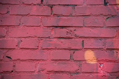 Brick wall painted in red Stock Photos