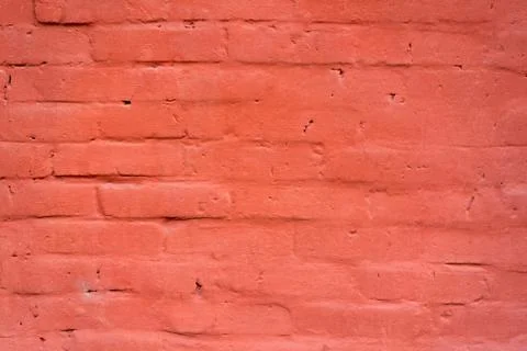 Brick wall painted with thick red paint Stock Photos