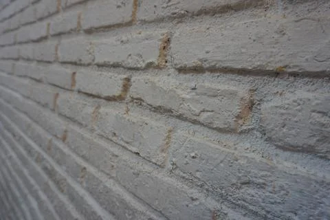 The brick wall is painted white. Old brick wall. Stock Photos