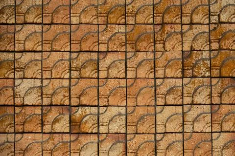 A brick wall with a pattern of squares and triangles 写真素材