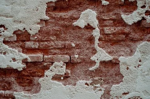 Brick wall with pieces of plaster. Wall of an old building in need of renov.. Photos