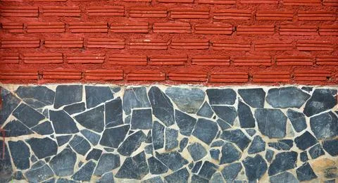A brick wall with a red brick border and a blue brick border Stock Photos
