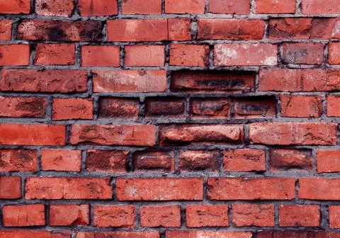 Brick wall with red brick, red brick background. Old cracked red bricks textu Foto stock