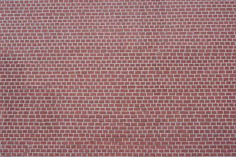 The brick wall is red -brown with white joints. Textured background Stock Photos