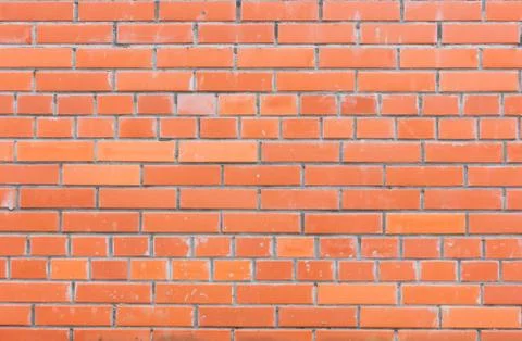 Brick wall of red decorative bricks. Classic brickwork.. Stock Photos
