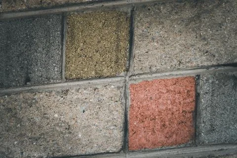 A brick wall with a red square in the middle Stock Photos
