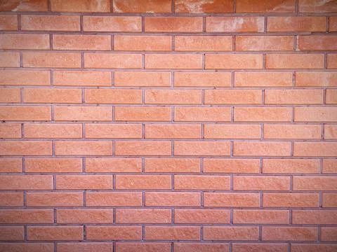 Brick wall of a reddish hue, texture, design Stock Photos