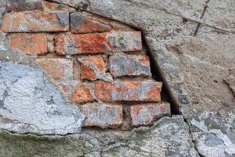 Brick wall with the rest of the plaster on an old building with a distinctive Stock Photos