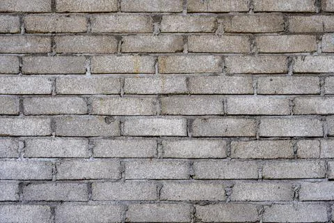 Brick wall with a rough texture and a few holes Stock-Fotos