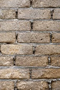 Brick wall with a rough texture and a few holes Foto stock