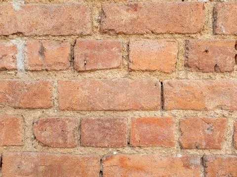 Brick wall showing textured surface and mortar joints Stock Photos