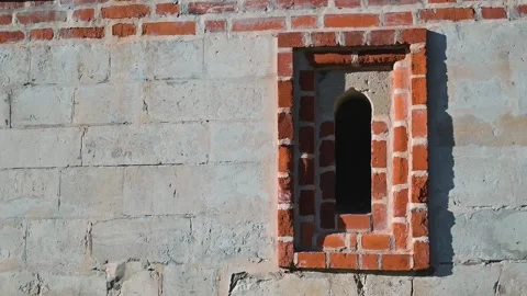 A brick wall shows window frames that are partially completed or in various Vídeos de archivo 344528045