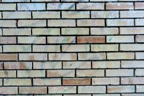 Brick wall with single orange bricks close up structure Stock Photos