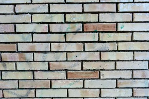 Brick wall with single orange bricks close up structure Stock Photos