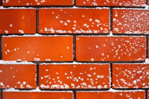 Brick wall with snow on it after snowfall Stock Photos