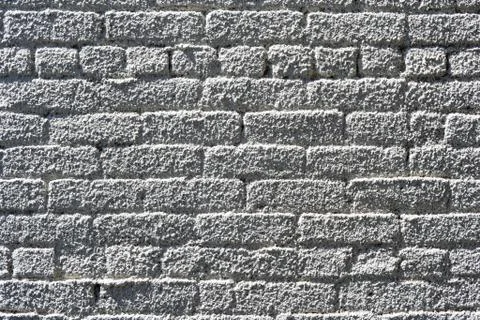 A brick wall sprayed with white stucco Stock Photos