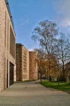 Brick Wall, Stone Path, Tall Trees and Church Tower, German Town Stock Photos