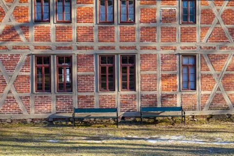 Brick wall texture background on day noon light with windows and benhes. Northen Stock Photos