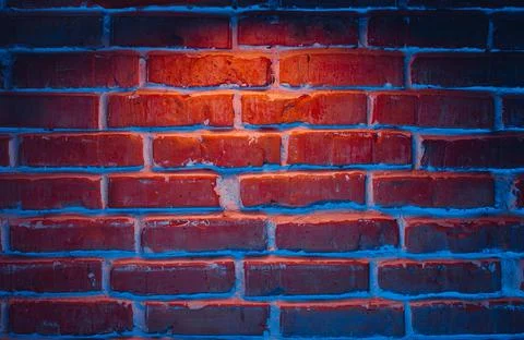 Brick wall texture background in red and blue neon lights Foto stock