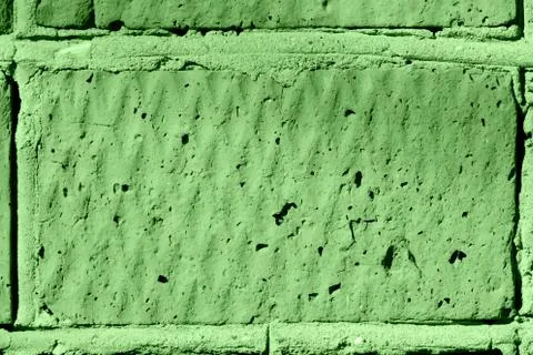 Brick wall texture close-up lit by the sun. Abstract background green color 스톡 사진