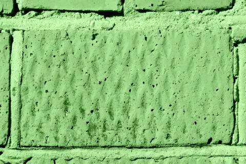 Brick wall texture close-up lit by the sun. Abstract background green color Stockfoto's
