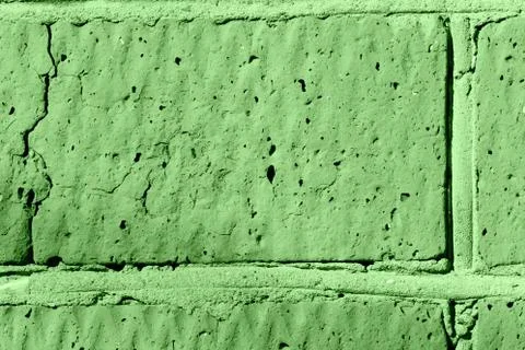 Brick wall texture close-up lit by the sun. Abstract background green color Foto stock