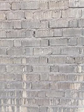 Brick wall texture covered with white cement mortar Stock Photos
