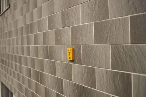 Brick wall texture, decorative stone with yellow sign Stock Photos