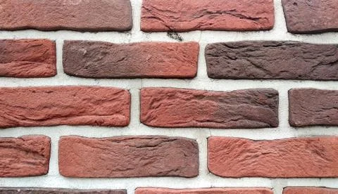 Brick wall texture in different red hues for background and Wallpaper Stock Photos