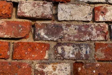 Brick wall texture featuring red, white, and weathered tones in natural lighting Stock Photos