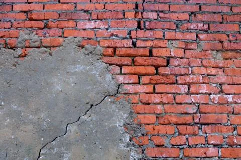 Brick wall texture partially plastered Фото