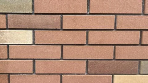 Brick wall texture showing different shades and patterns in warm tones in a.. Stock Photos