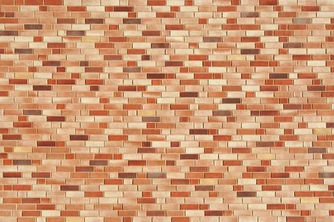Brick wall texture in warm tones. Exterior view. New beige building. Stock Photos