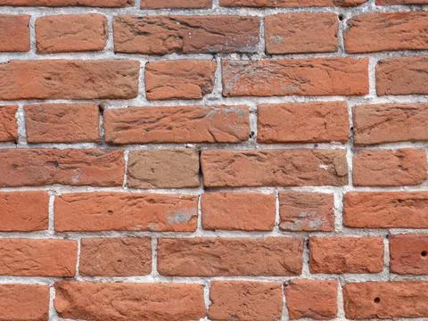 Brick wall texture. White layers of cement are visible Stock Photos