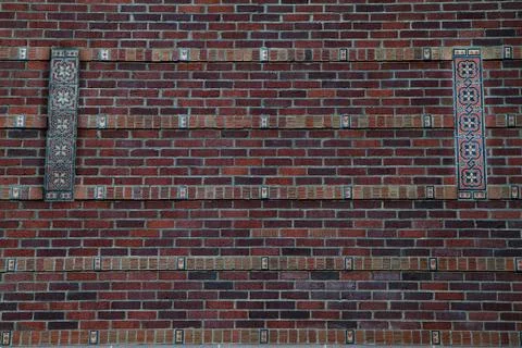 Brick wall with tile design Stock Photos