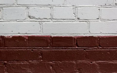 Brick wall two-color wall painted in white and burgundy colors. Brick wall full Stock Photos